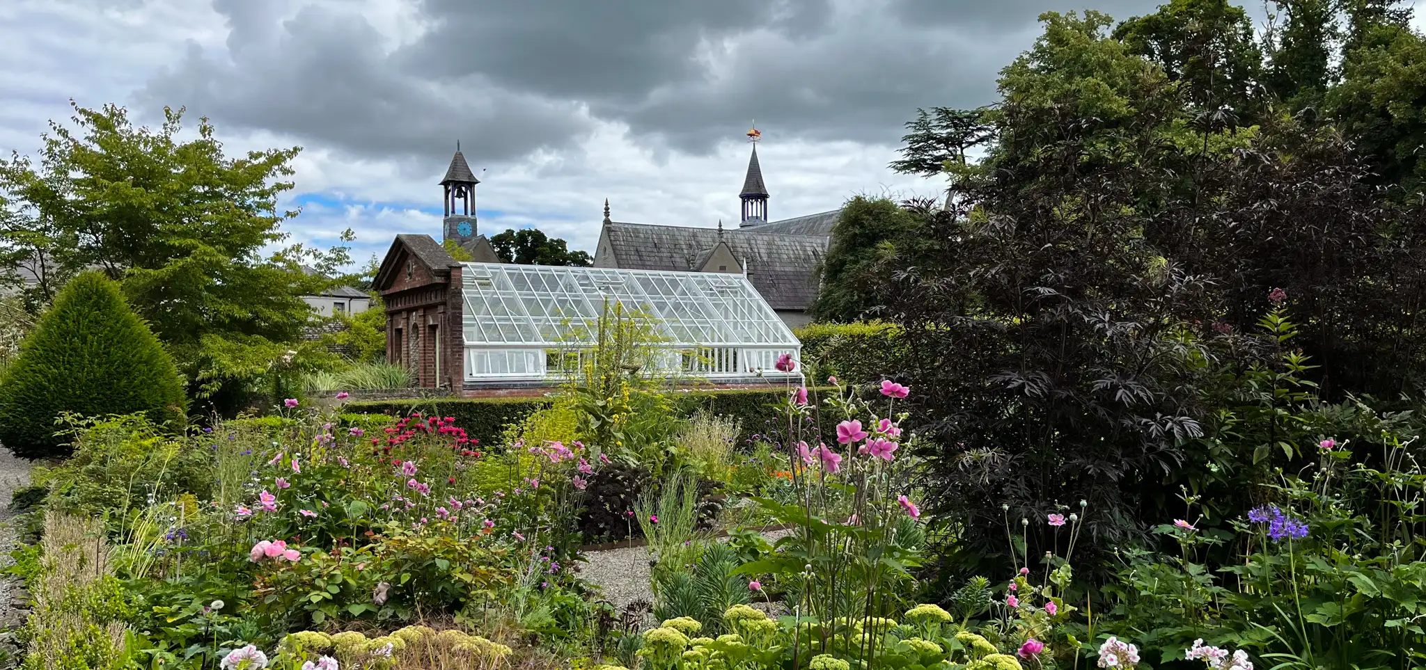 A white greenhouse in a garden